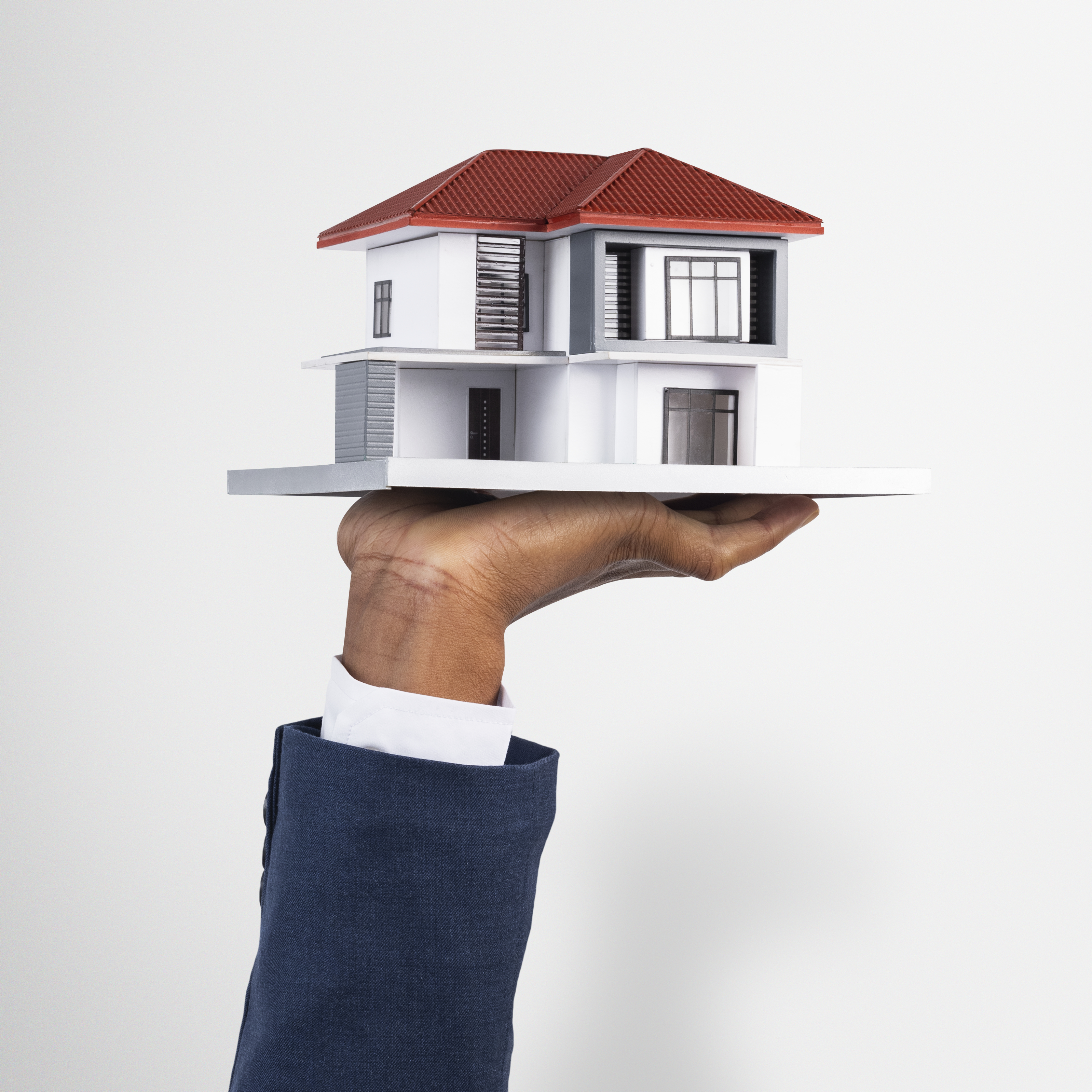 Modern home model held by hand